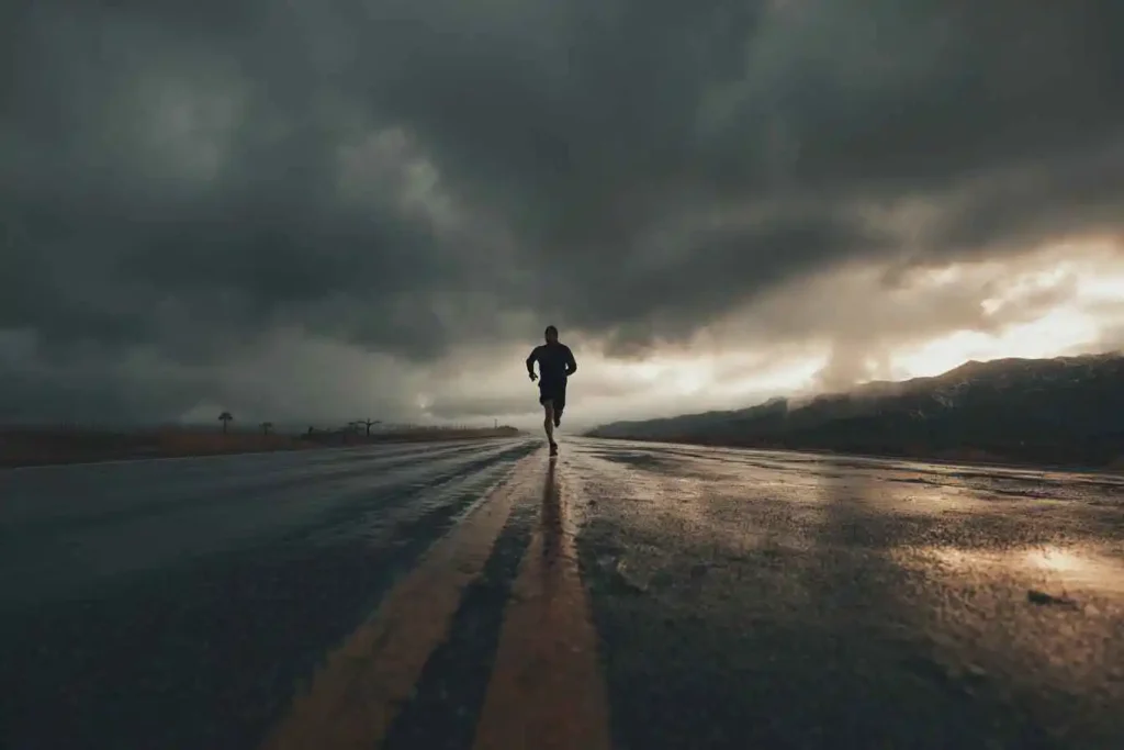 A lone athlete running at dawn, symbolizing discipline and consistency.