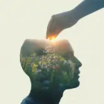 An illustration showing a human head silhouette with a garden growing inside, being watered to symbolize the cultivation of a positive mindset routine.