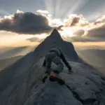 A determined climber with an unstoppable mindset ascending a rugged mountain, symbolizing the mental toughness needed for lasting success. Develop an unstoppable mindset